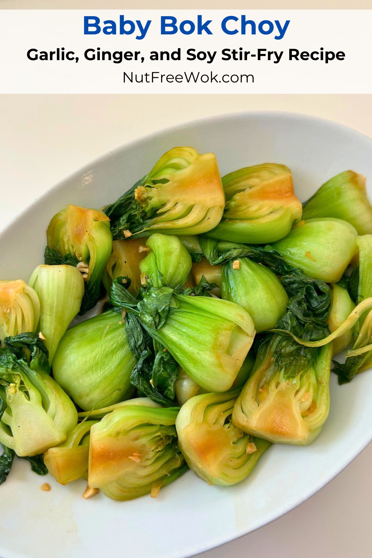 Baby bok choy stir fried with minced garlic and ginger in a white bowl