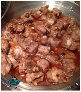 Spareribs with black bean sauce in a glass plate in a pot