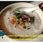 bowl of congee with toppings in a cream colored bowl, with a chinese soup spoon on the side