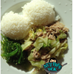 Kalua pig and cabbage plated with rice and seaweed salad
