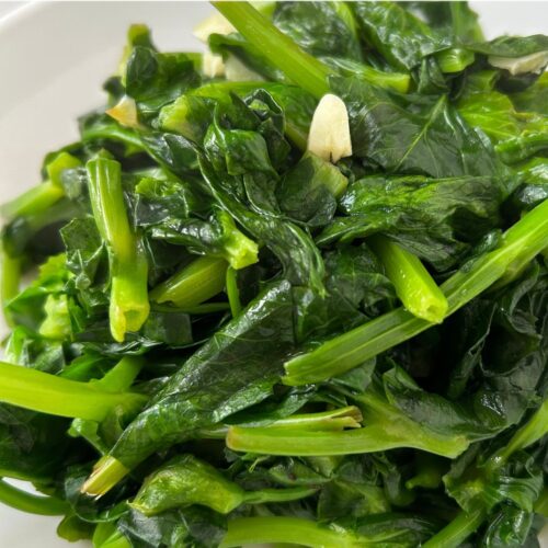 close up of pea shoots stir fried with garlic and ginger