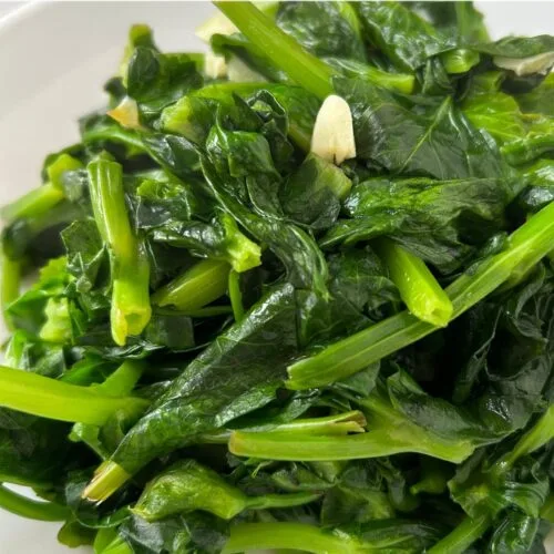 close up of pea shoots stir fried with garlic and ginger