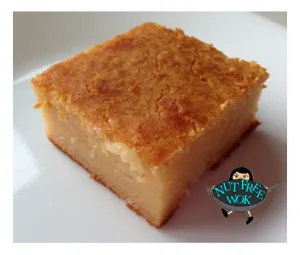 close up view of butter mochi with egg on a white plate
