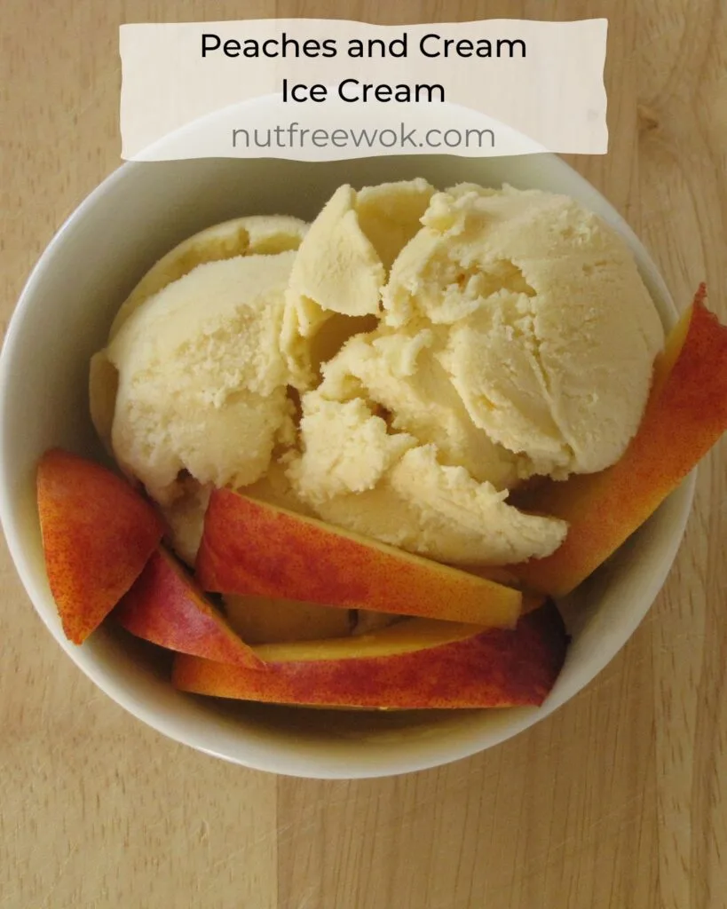 peaches and cream ice cream in a bowl and garnished with fresh peaches