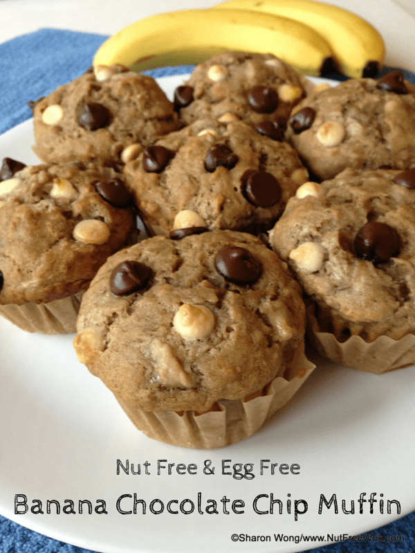 banana chocolate chip muffins on a plate with bananas in the background