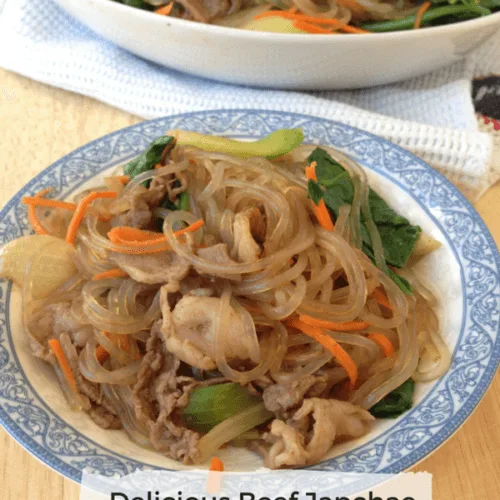 small blue and white plate containing delicious beef japchae