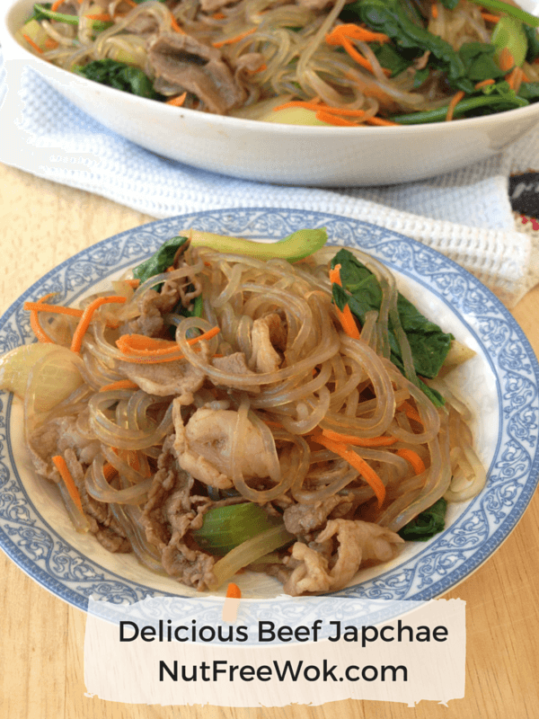 small blue and white plate containing delicious beef japchae