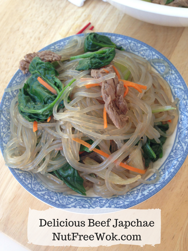 blue and white plate containing delicious beef japchae