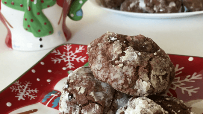 Baking with children, Chocolate Crinkle Cookies on a snowman festive plate with a snowman cup and a large plate of cookies in the background