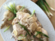 Bok Cheet Gai Slow Cooker Chinese White Cut Chicken on a white platter with some ginger, green onions, and sauce