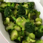 Broccoli Stir Fry with Ginger and Garlic Sauce in a white oval bowl