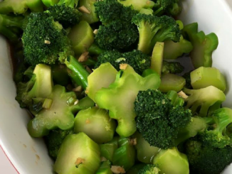 Broccoli Stir Fry with Ginger and Garlic Sauce in a white oval bowl