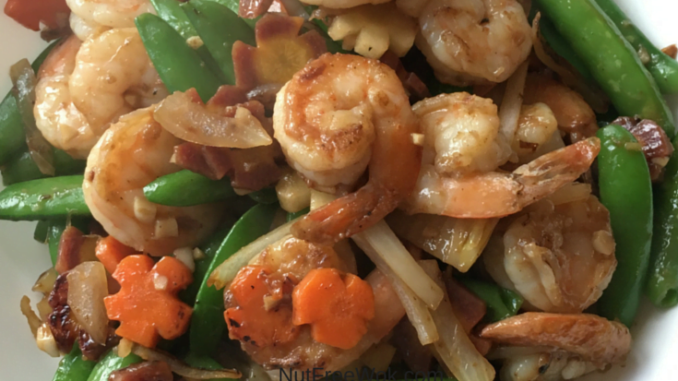 Shrimp stir fry in a white serving dish Happiness is a Shrimp Stir Fry with Spring Vegetables Recipe