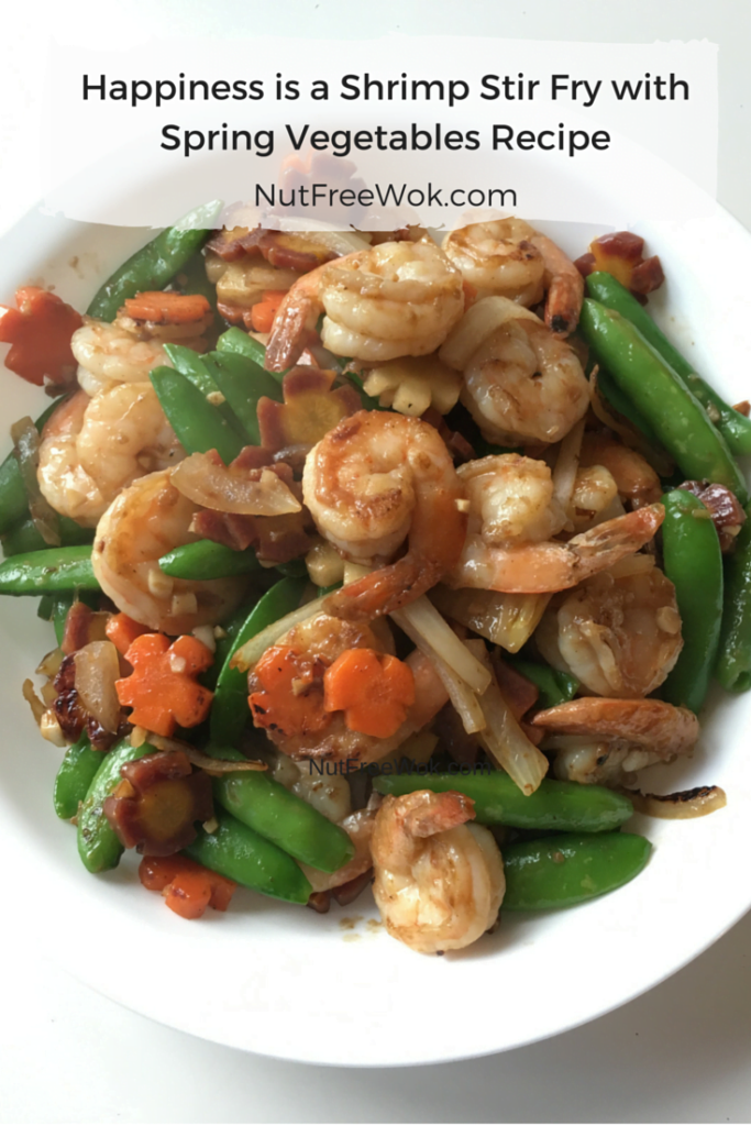 close up photo of a shrimp and vegetable stir-fry in a white serving dish.