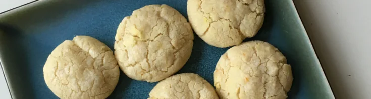 lemon vanilla crinkle cookies on a square blue plate