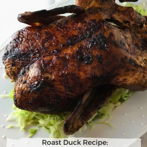 chinese inspired roast duck on a platter with lettuce