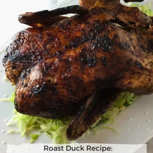 chinese inspired roast duck on a platter with lettuce