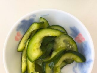 sweet pickled cucumbers served in a small round dish