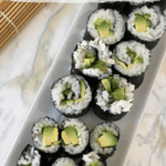 Easy and Allergy Friendly Cucumber and Avocado Sushi Rolls on a white rectangular serving dish