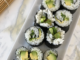 Easy and Allergy Friendly Cucumber and Avocado Sushi Rolls on a white rectangular serving dish