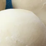 close up of mochi ice cream on a blue plate