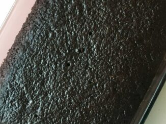 Classic Chocolate wacky cake baked in a 9x13 pan, looks very dark and chocolatey.