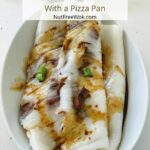 Char siu rice rolls plated in a white oval dish and drizzled with a sweet soy sauce