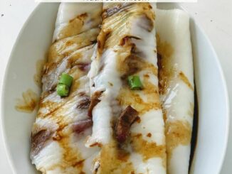 Char siu rice rolls plated in a white oval dish and drizzled with a sweet soy sauce