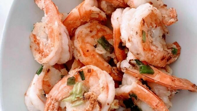 Stir fried shrimp in a white oval bowl