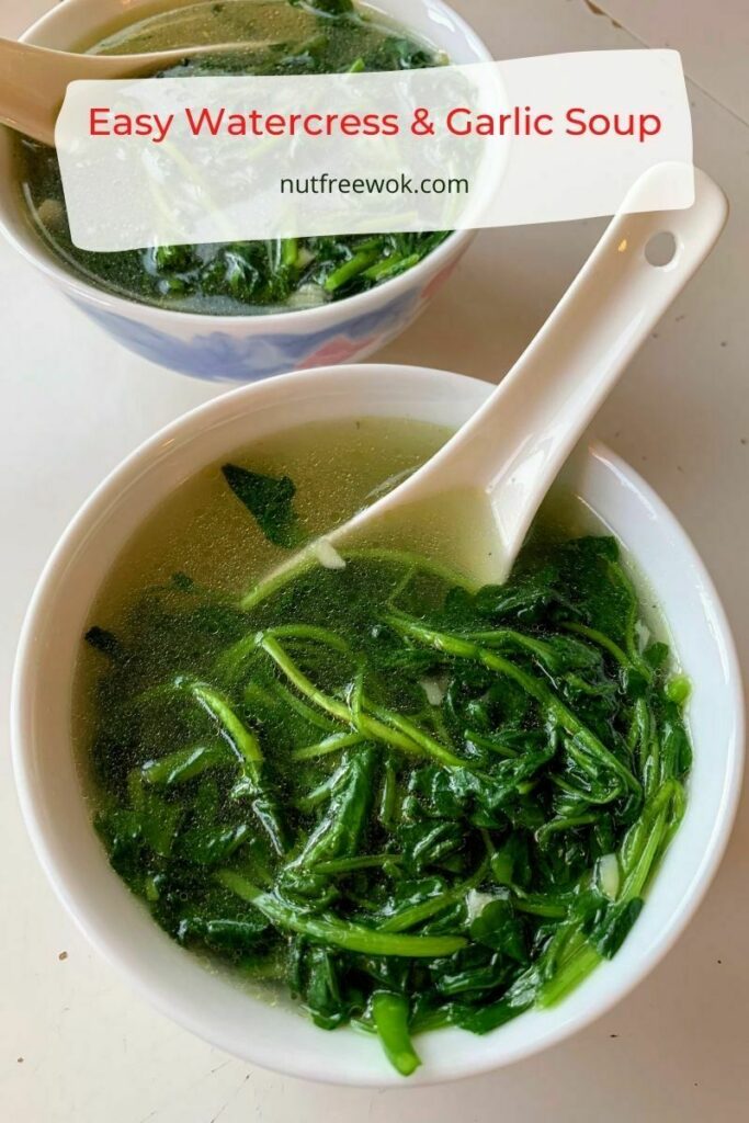 two bowls of watercress and garlic soup in a white soup bowl with white Chinese soup spoons