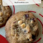 closeup of cranberry and white chocolate chip cookie on a silicone baking sheet