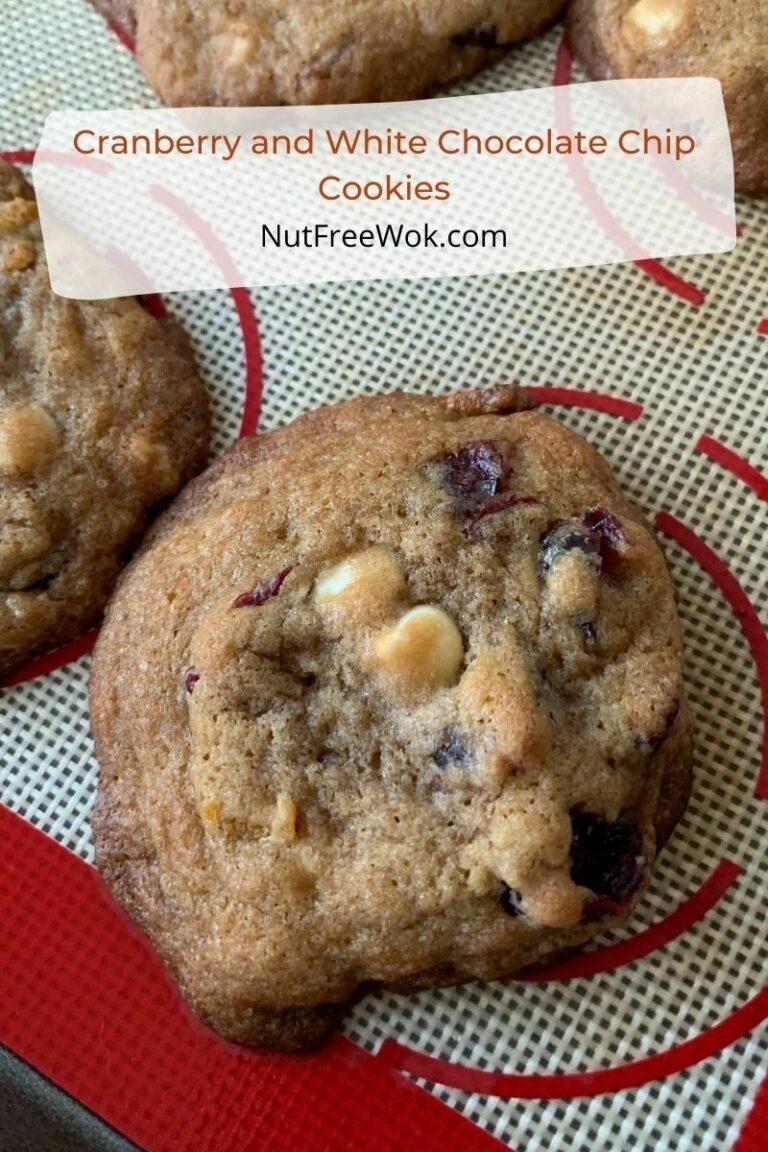 closeup of cranberry and white chocolate chip cookie on a silicone baking sheet