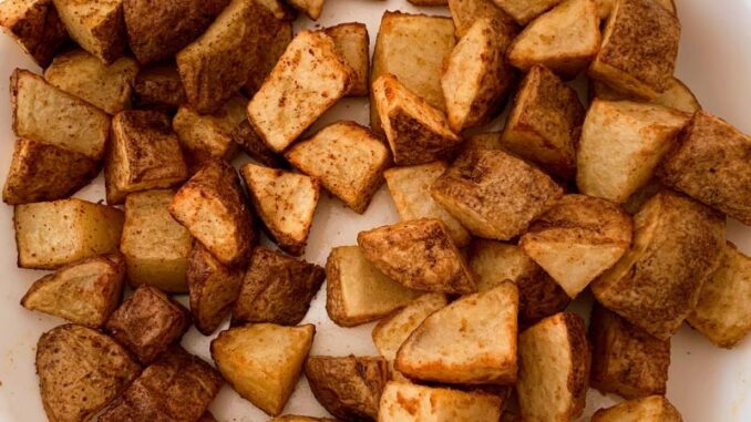 potato home fries on a white serving plate