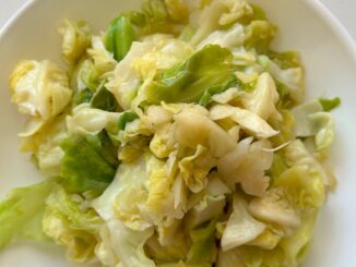 garlicky cabbage with fish sauce in a white bowl