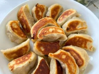 potstickers arranged in a circular design with the crispy bottoms up