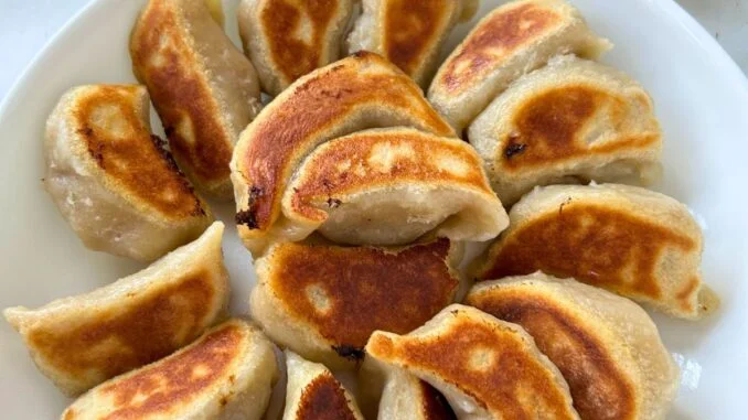 potstickers arranged in a circular design with the crispy bottoms up