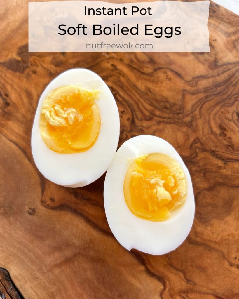 close up of a soft boiled egg cut in half on a wooden cutting board