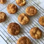 snickerdoodles resting on a cooling sheet