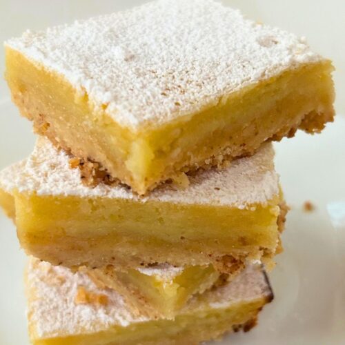 Meyer lemon bars with brown butter crust, cut pieces are arranged in a stack