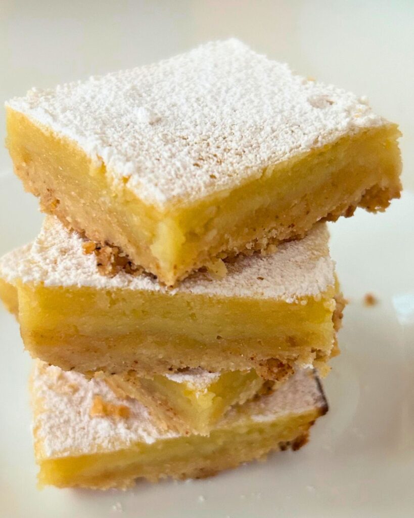 side view close up of 4 meyer lemon bars arranged in a stack