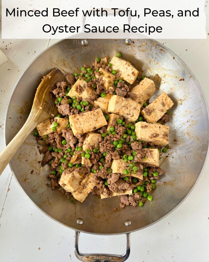 Minced Beef with Tofu, Peas, and Oyster Sauce freshly cooked in a pan, with a wooden spoon on the side