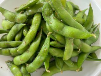 Edamame with Sichuan peppers in a white bowl