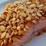close up of baked salmon topped with rice crispy cereal