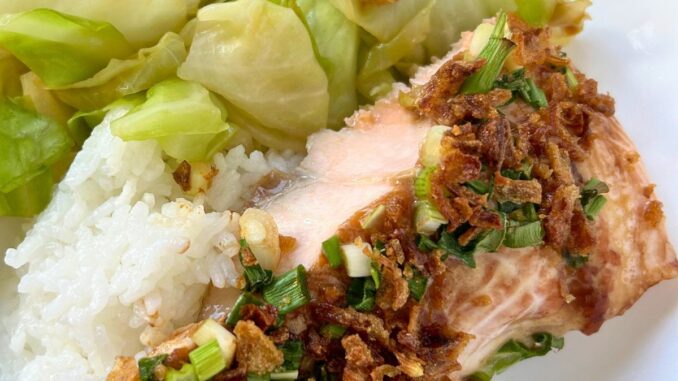 baked salmon served with stir-fried cabbage and rice.