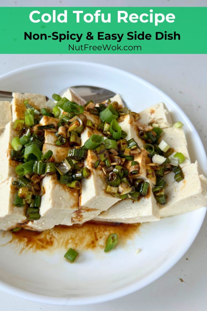 cut pieces of cold tofu, topped with soy sauce, sesame and scallion dressing, served in a white bowl