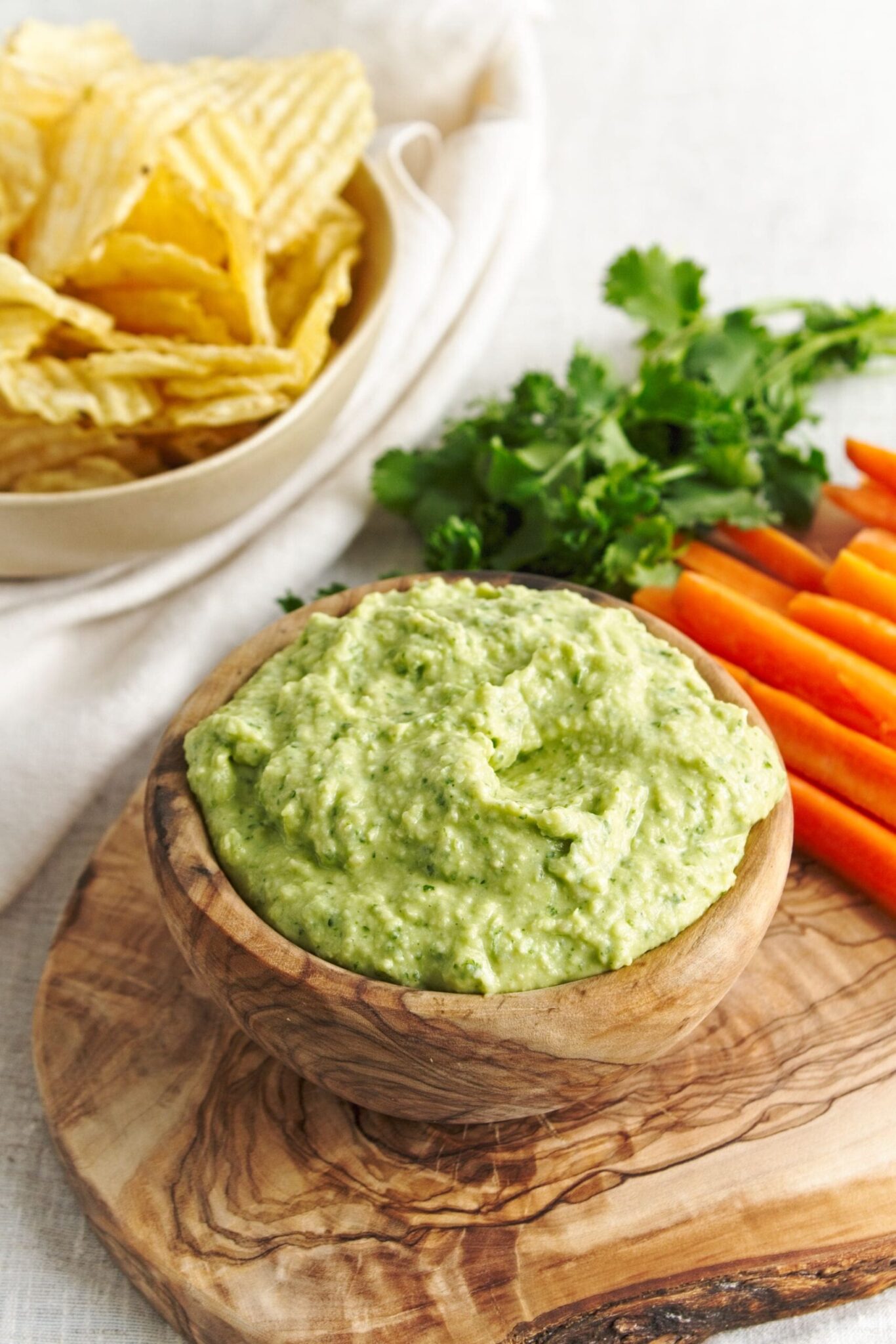 Green Goddess Hummus served in a wooden bowl