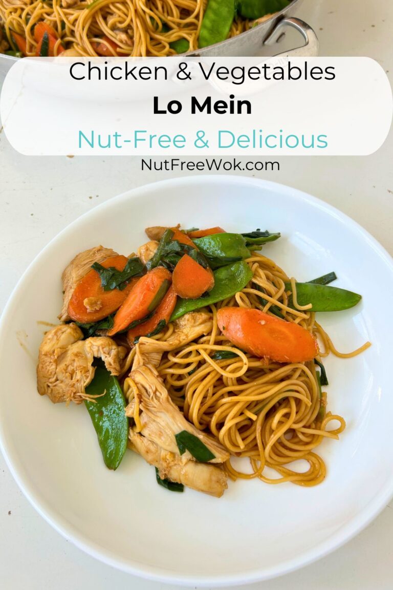 chicken and vegetables lo mein in a white plate