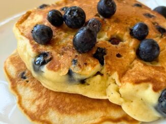 blueberry pancakes topped with fresh blueberries