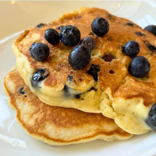 blueberry pancakes topped with fresh blueberries