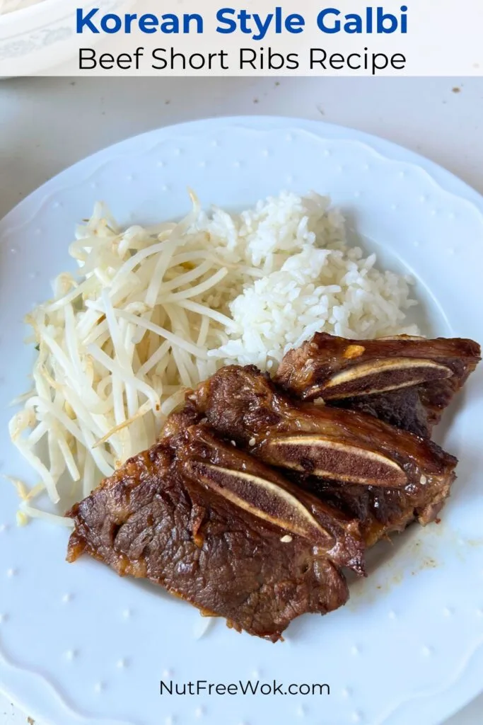 Plate of Korean style beef short ribs with rice and cooked mung bean sprouts.